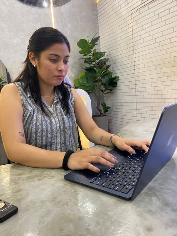 Joan Saycon working at a laptop
